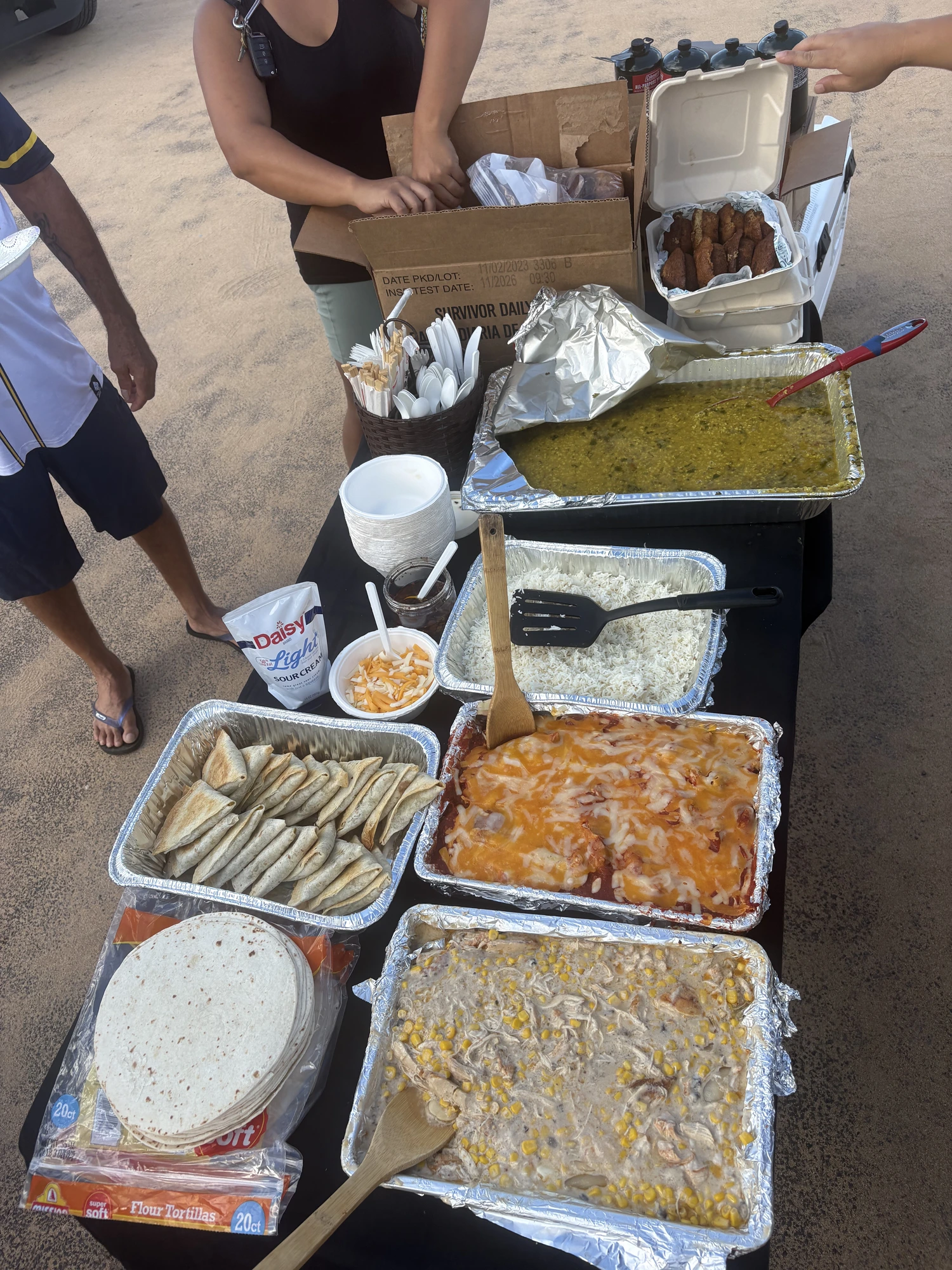 Feed the Community volunteers sharing shakas after a beachside meal distribution